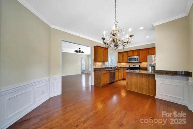 a view of a kitchen with a sink stove and refrigerator