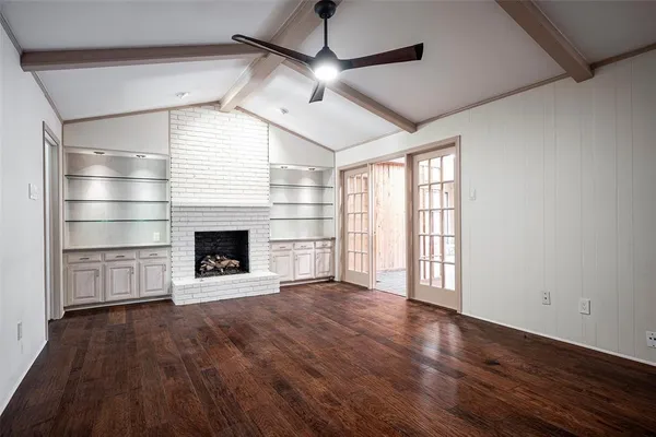 a view of a room with wooden floors and fireplace