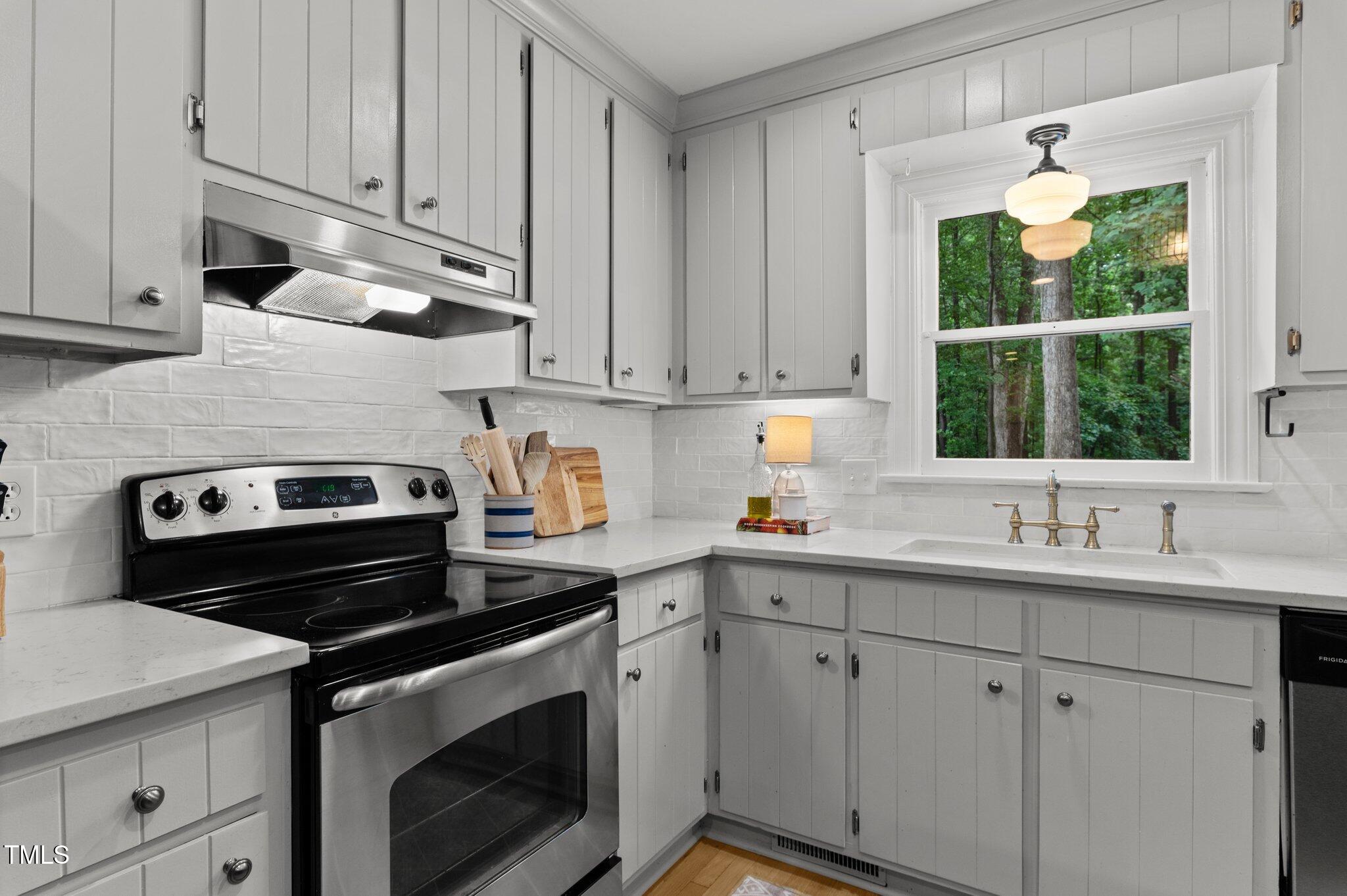 3016 Bolo Trail Raleigh, NC 27615 - Photo 11 of 28 a kitchen with a sink stove and cabinets