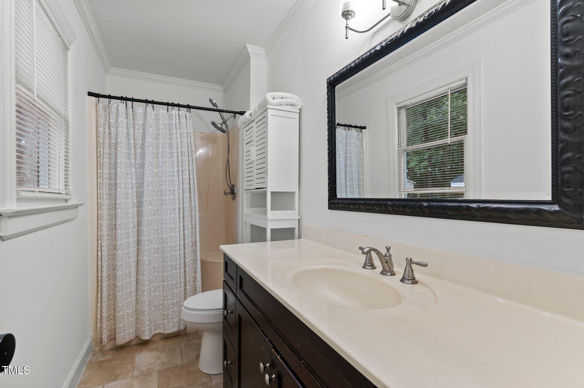 3016 Bolo Trail Raleigh, NC 27615 - Photo 17 of 28 a bathroom with a sink a toilet and a mirror