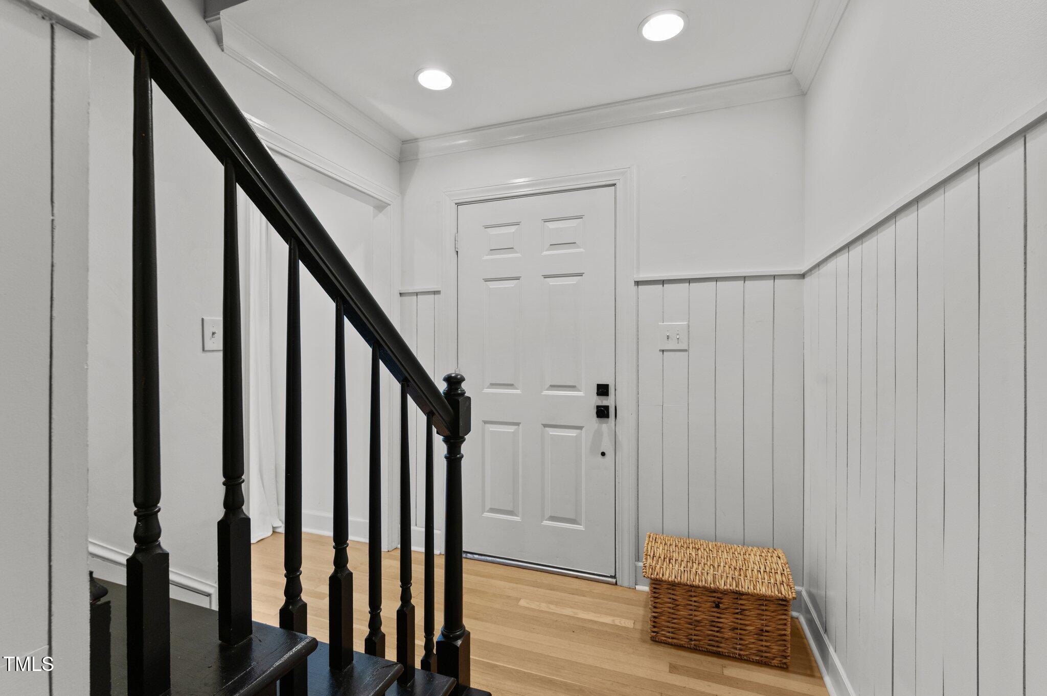 3016 Bolo Trail Raleigh, NC 27615 - Photo 3 of 28 a view of a hallway with wooden floor and staircase