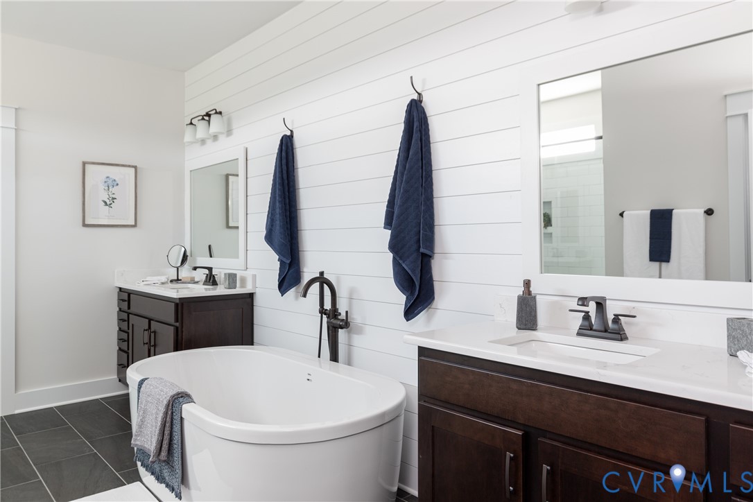 16852 Sheppards Fold Way Beaverdam, VA 23015 - Photo 17 of 30 a bathroom with a double vanity sink and mirror