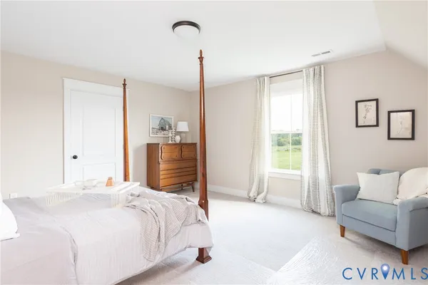 a bedroom with a bed and a couch