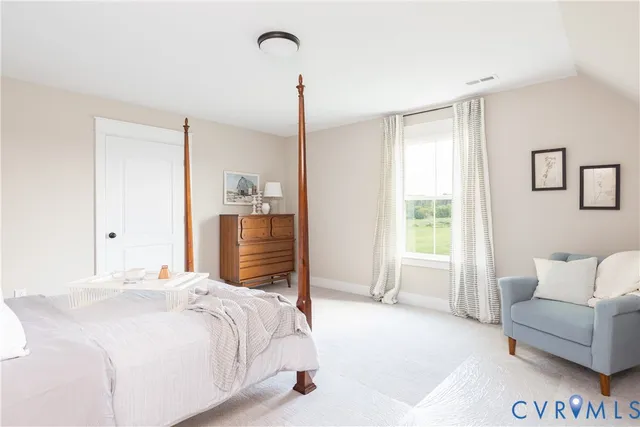 a bedroom with a bed and a couch