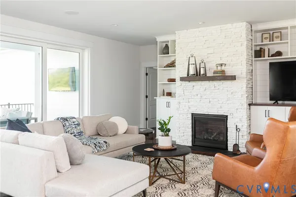 a living room with furniture fireplace and a flat screen tv