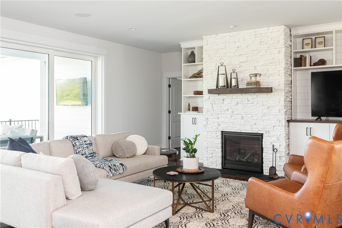16852 Sheppards Fold Way Beaverdam, VA 23015 - Photo 8 of 30 a living room with furniture fireplace and a flat screen tv