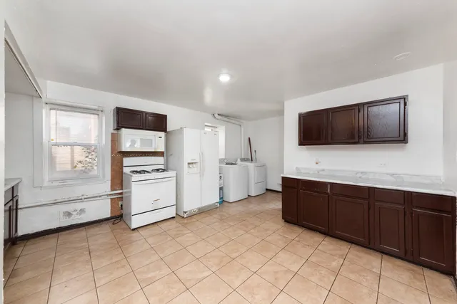 a kitchen with stainless steel appliances a refrigerator and a stove top oven