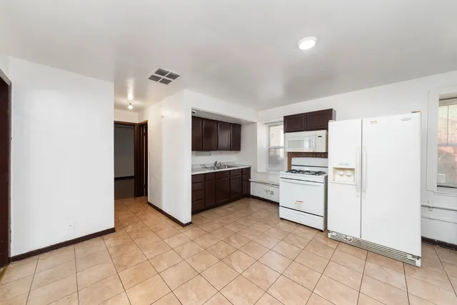 a kitchen with stainless steel appliances a refrigerator and a stove
