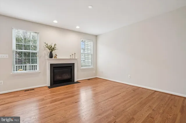 a view of kitchen with granite countertop stainless steel appliances and wooden floor