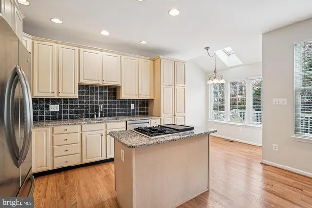 a kitchen with a stove and a wooden floor