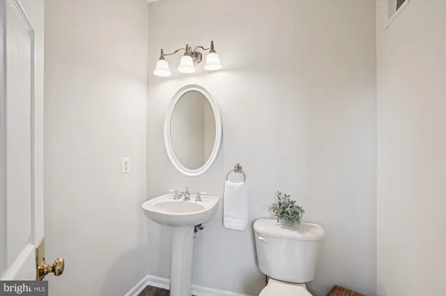 a spacious bedroom with a bed and a chandelier