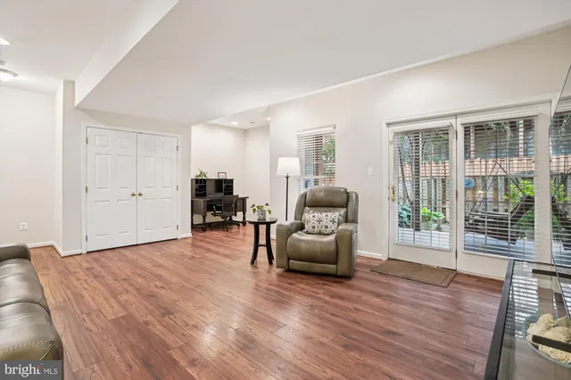 a view of a workspace with furniture and wooden floor