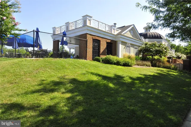 a view of a house with backyard porch and sitting area