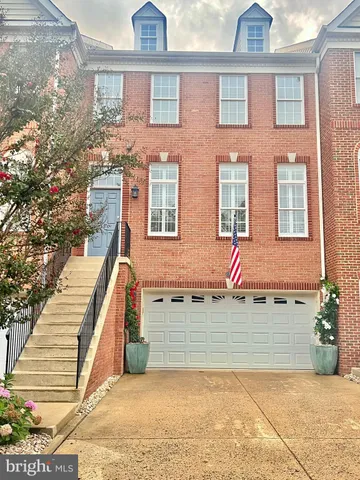 a view of a house with many windows and a tree