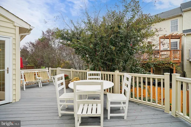 a view of a hallway with wooden floor and a bathroom