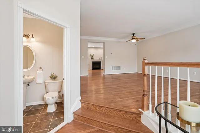 a view of empty room with wooden floor and window