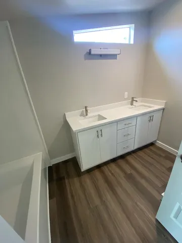 a room with a sink and mirror
