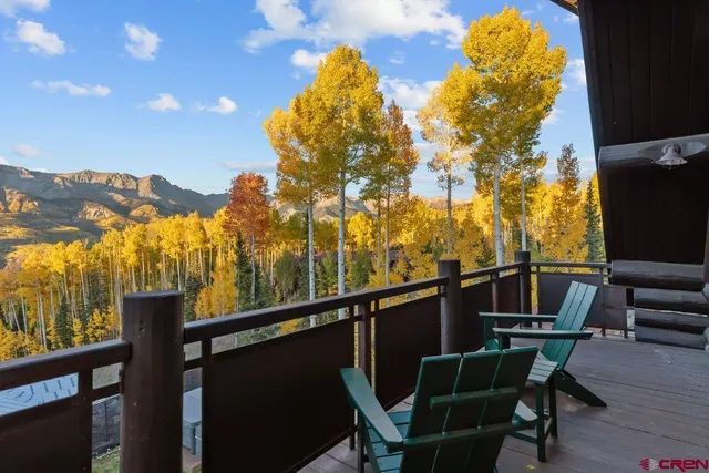 a view of a chairs and table in the balcony