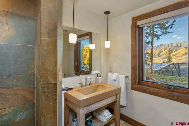 a bathroom with a sink a mirror and a window