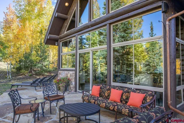 a balcony with chairs and a table