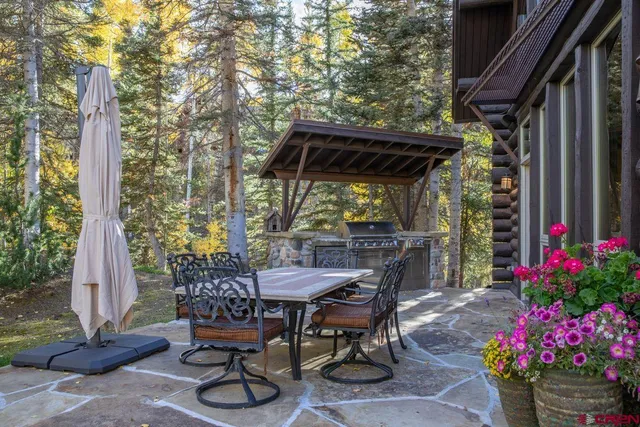 a view of patio with a table and chairs and potted plants