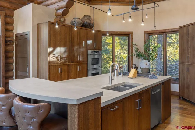 a kitchen with a table and chairs