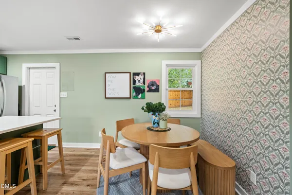 a dining room with furniture and window