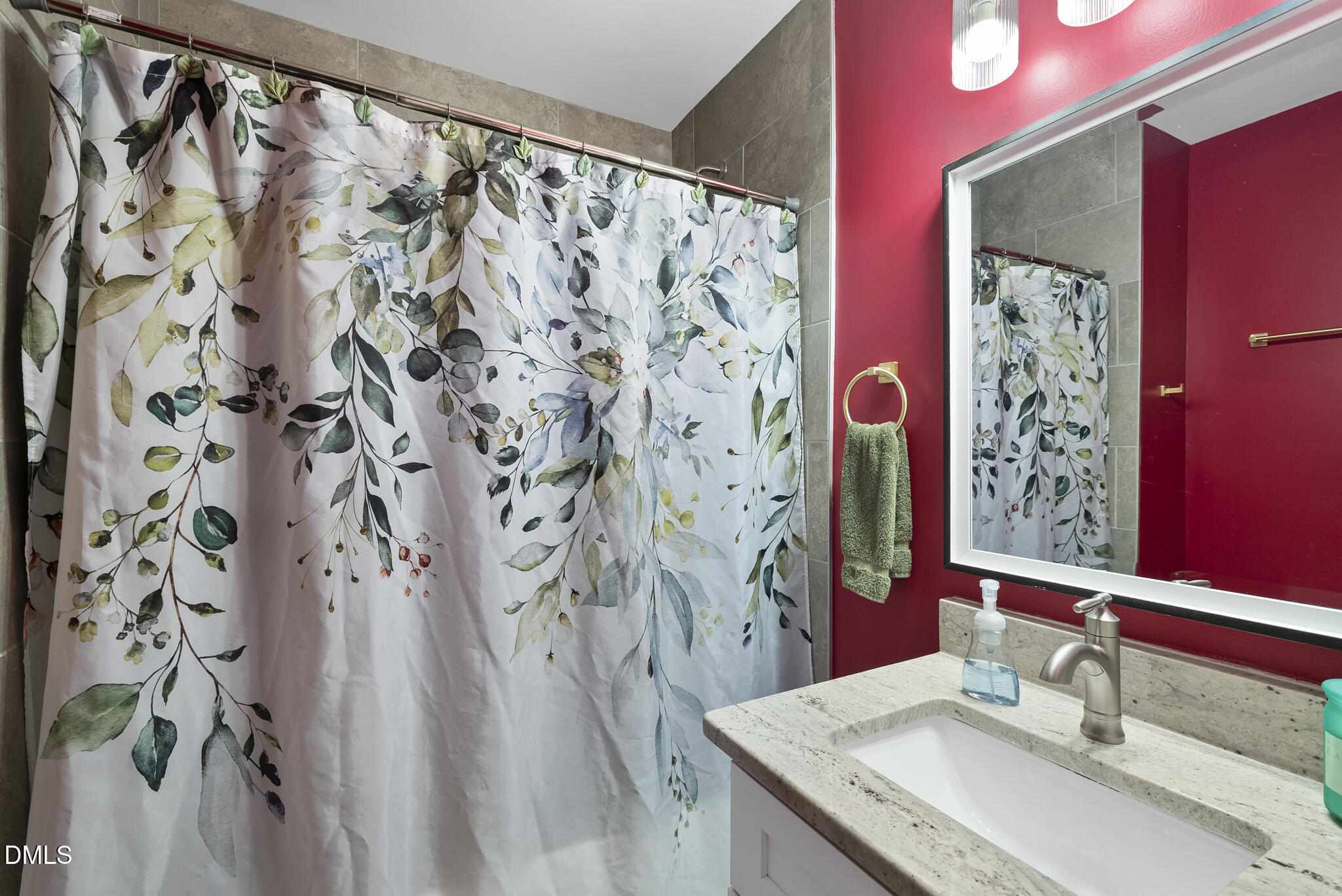 1002 Bacon Street Durham, NC 27703 - Photo 15 of 31 a bathroom with a granite countertop sink a mirror and shower curtain
