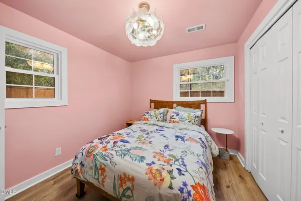 a bedroom with a bed and a chandelier