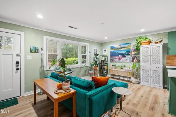 a living room with furniture and a floor to ceiling window
