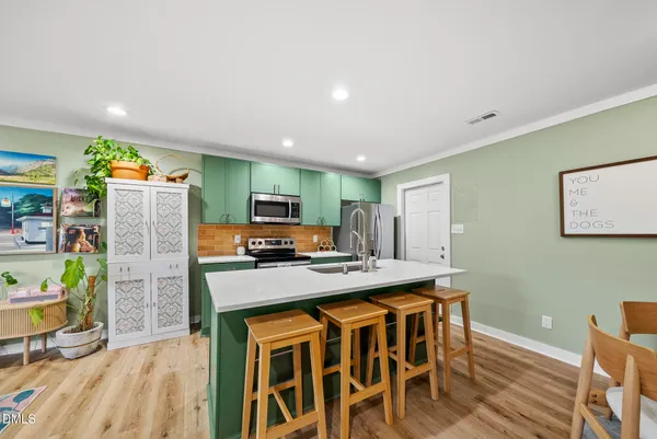 a view of a dining room with furniture and a wooden floor