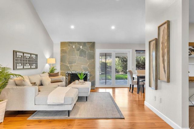 a spacious bedroom with a bed a couch and a potted plant