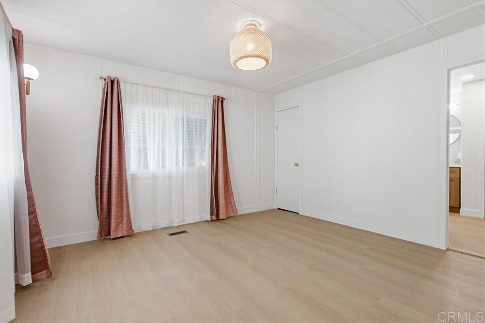 650 South Rancho Santa Fe Road, Unit 291 San Marcos, CA 92078 - Photo 18 of 48 an empty room with closet and windows