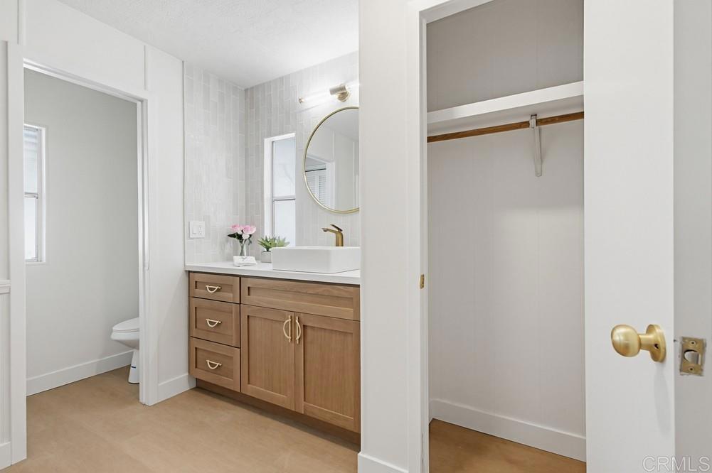 650 South Rancho Santa Fe Road, Unit 291 San Marcos, CA 92078 - Photo 22 of 48 a bathroom with a sink vanity and a mirror