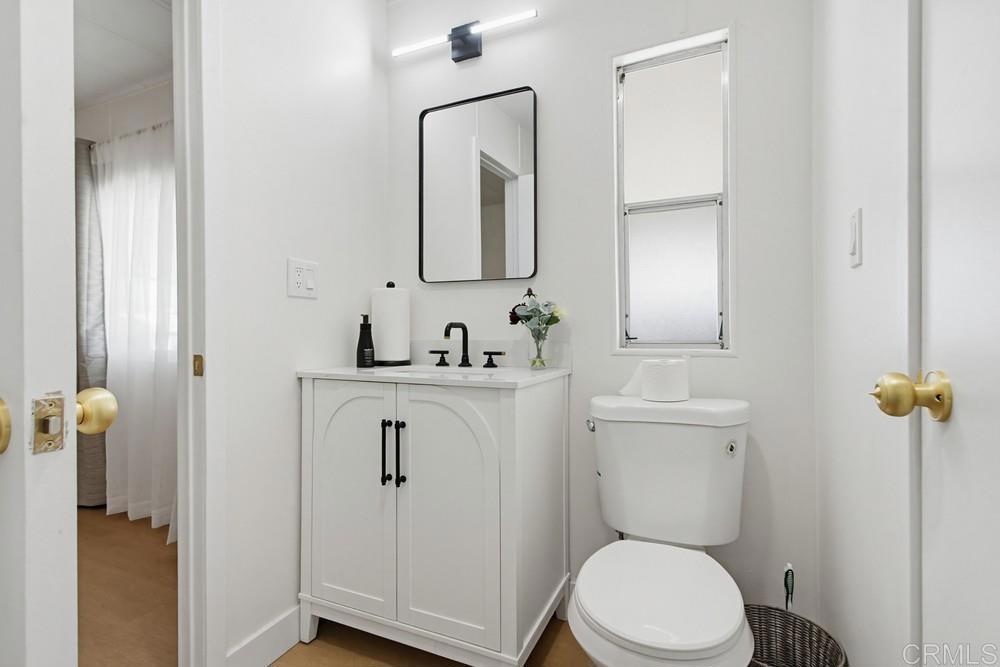 650 South Rancho Santa Fe Road, Unit 291 San Marcos, CA 92078 - Photo 25 of 48 a bathroom with a toilet a sink and mirror