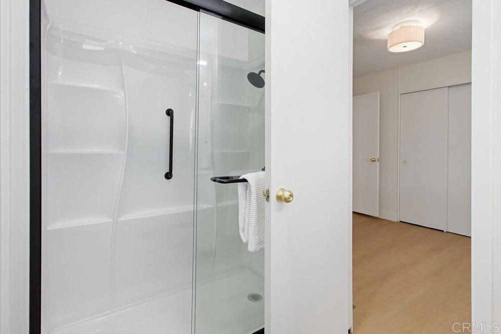 650 South Rancho Santa Fe Road, Unit 291 San Marcos, CA 92078 - Photo 26 of 48 a bathroom with a glass shower door