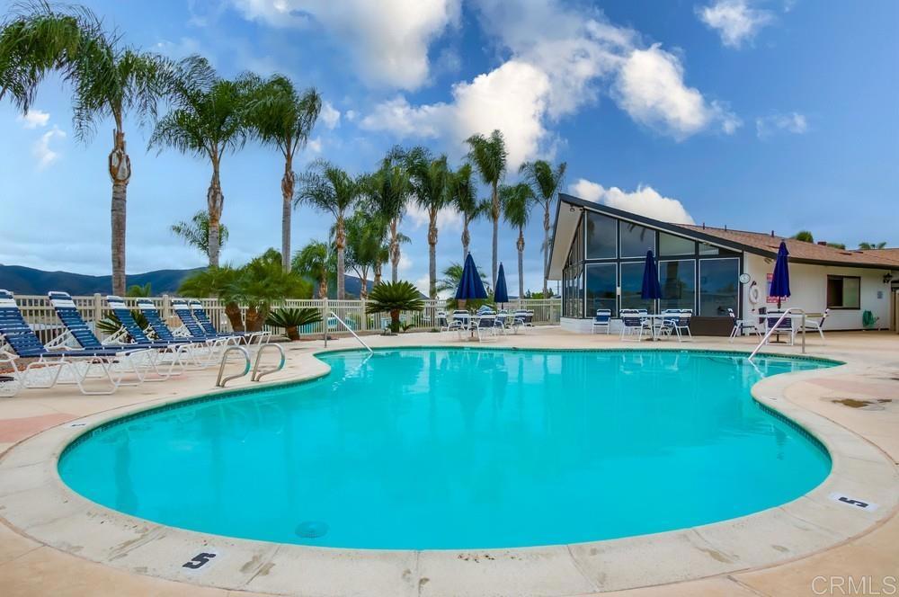 650 South Rancho Santa Fe Road, Unit 291 San Marcos, CA 92078 - Photo 37 of 48 a view of a swimming pool with outdoor seating and a garden