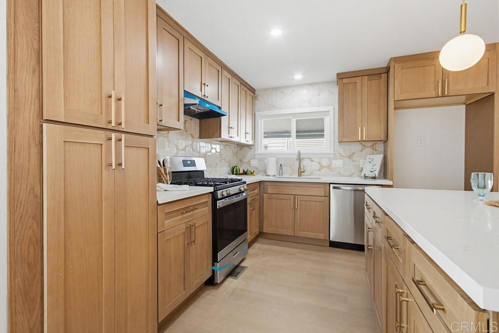 650 South Rancho Santa Fe Road, Unit 291 San Marcos, CA 92078 - Photo 10 of 48 a kitchen with stainless steel appliances granite countertop a sink a stove a refrigerator and cabinets