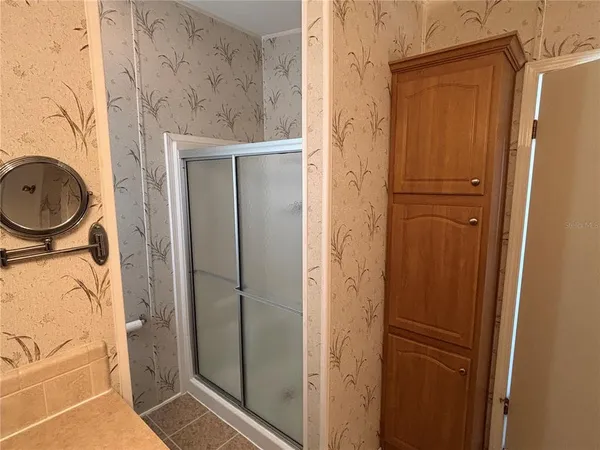 a bathroom with a granite countertop shower and a sink