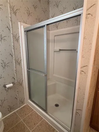 a bathroom with a glass shower door