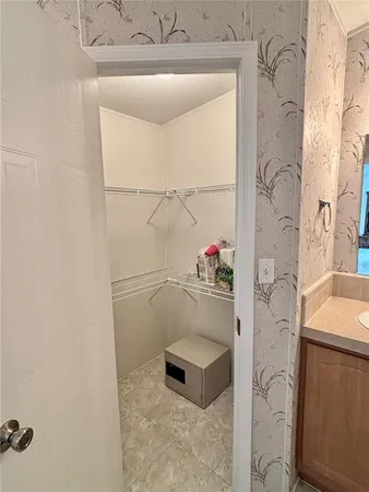 a bathroom with a tub shower sink and vanity