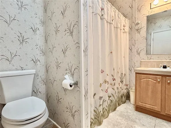a white toilet sitting next to a bathroom sink