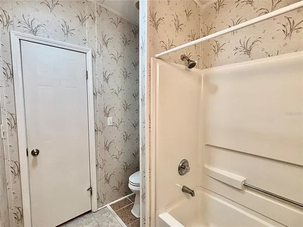 a bathroom with a shower and a toilet