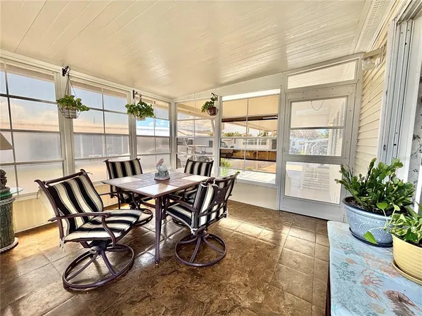 a dining room with furniture and wooden floor