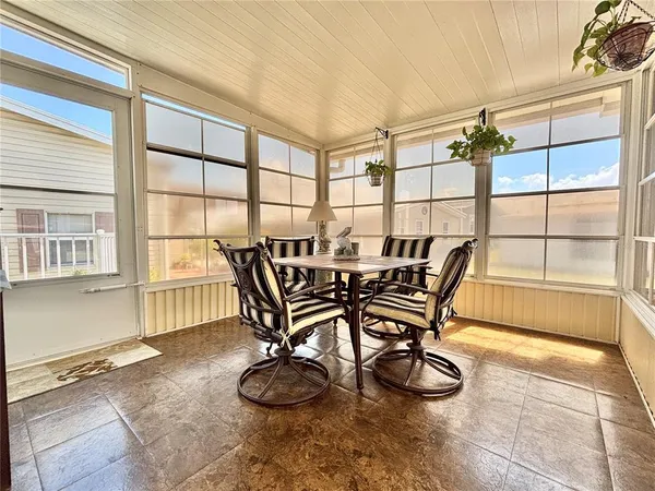 a view of a dining room with furniture and a window