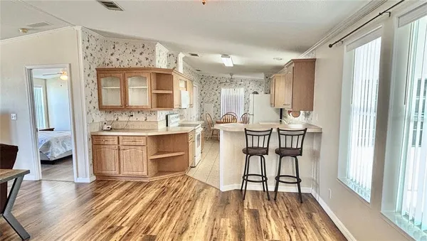 a view of a dining room with furniture and wooden floor