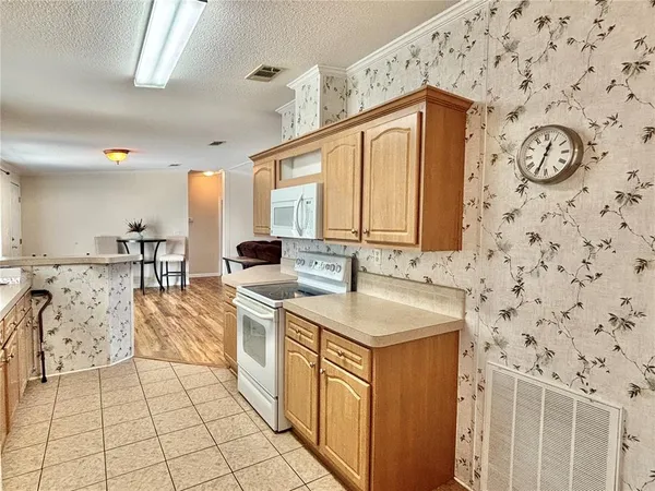 a kitchen with stainless steel appliances a stove a sink and a refrigerator