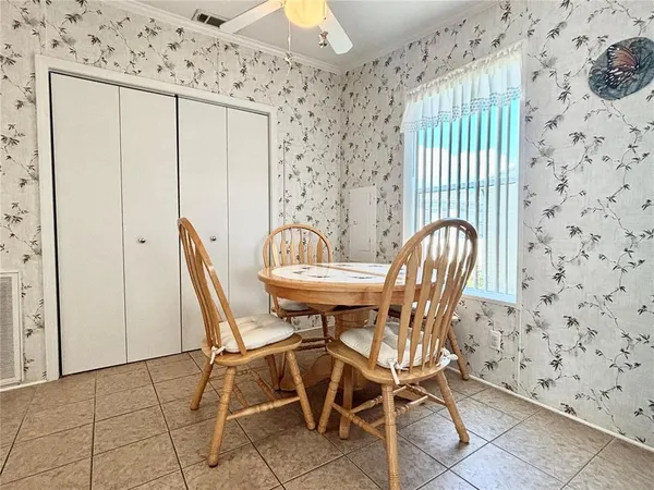 a view of a dining room with furniture and chandelier