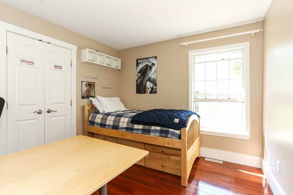 75 Deacon Court Barnstable, MA 02630 - Photo 16 of 30 a bedroom with a bed and wooden floor