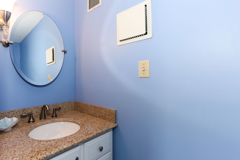 75 Deacon Court Barnstable, MA 02630 - Photo 20 of 30 a bathroom with a granite countertop sink and a mirror